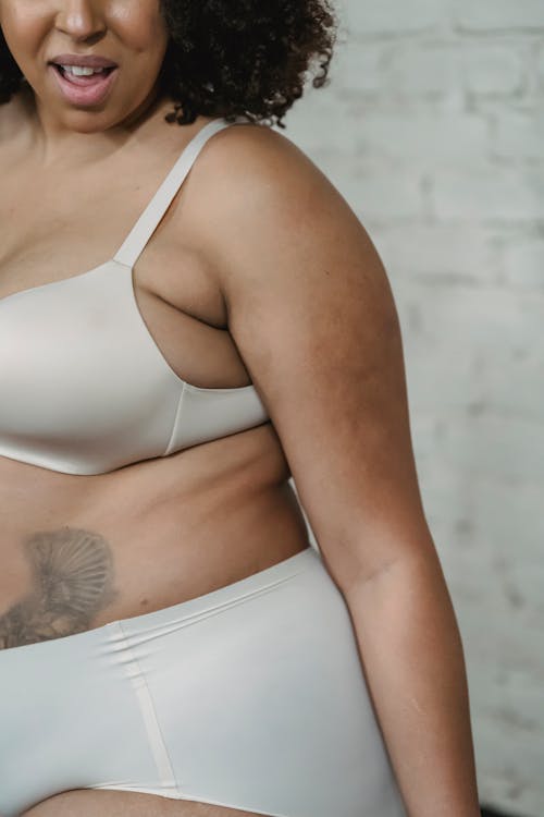 Crop tattooed black woman in underwear