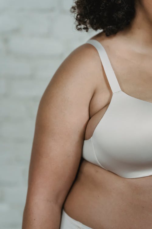 Crop overweight woman in underwear in studio