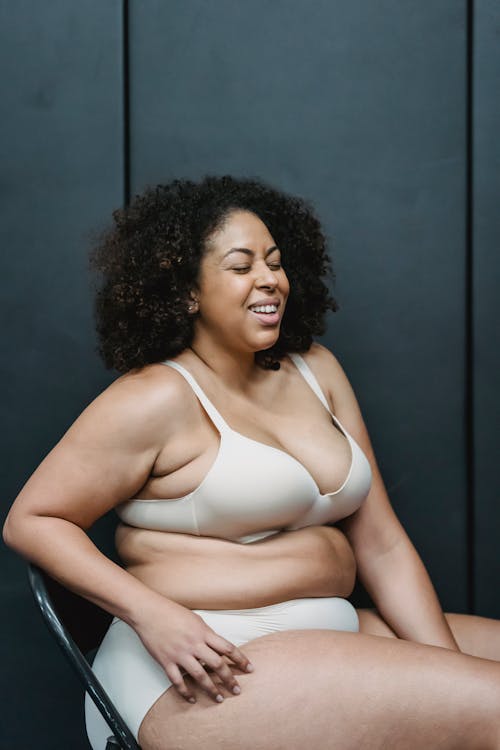 Smiling overweight black woman in underwear · Free Stock Photo