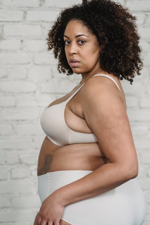 Confident overweight black woman in lingerie