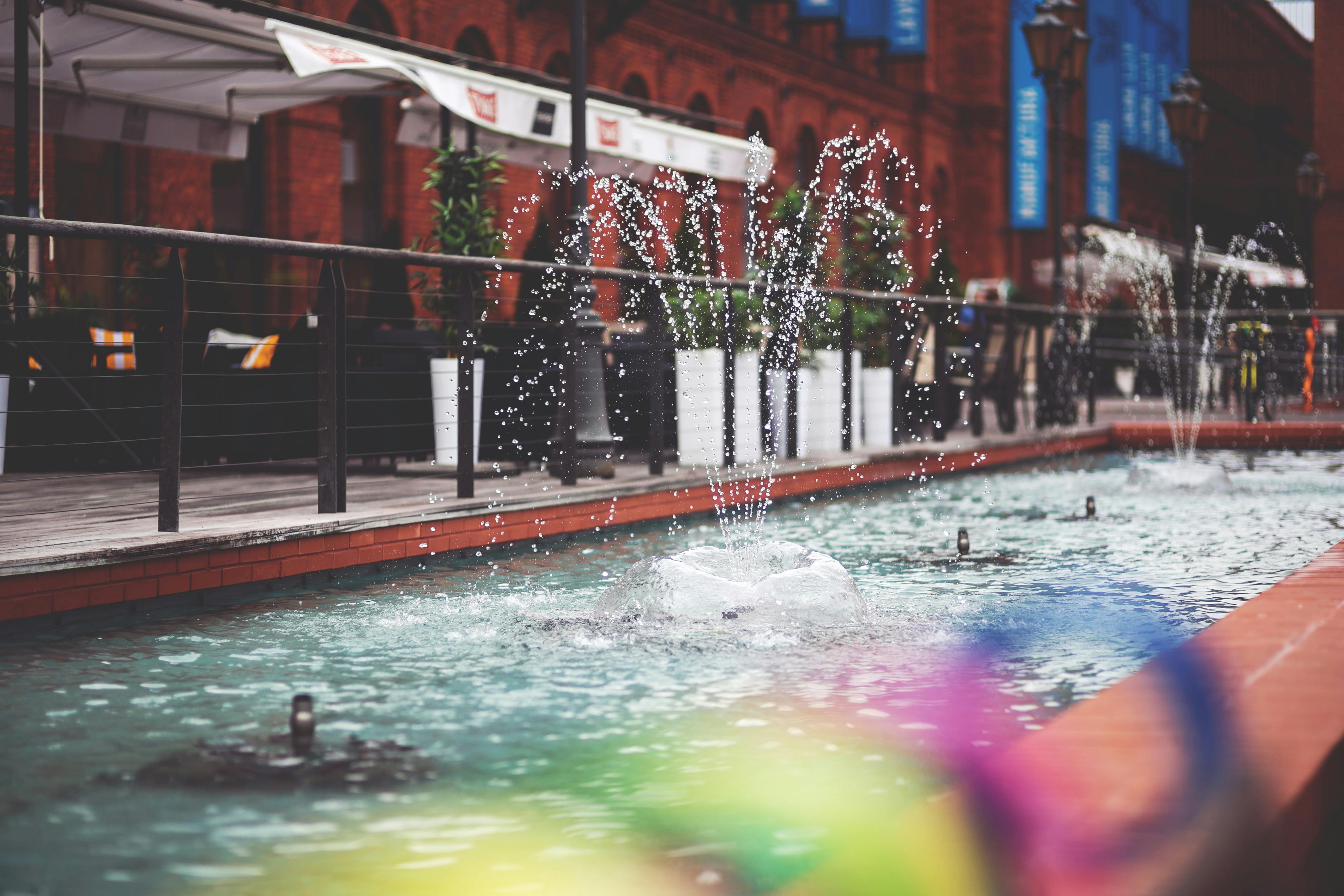 Dynamic fountains splashing water in the beautiful outdoors of Manufaktura, Lodz.