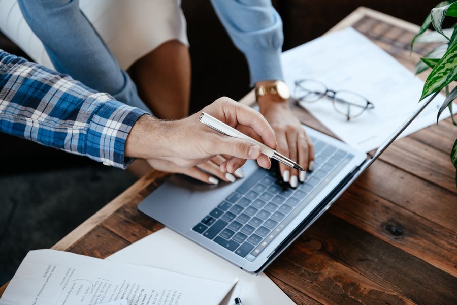 Coworkers collaborating over a laptop, photographed by Alexander Suhorucov on Pexels
