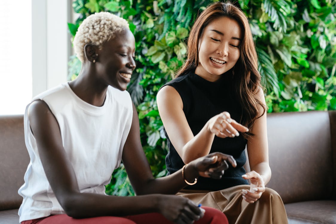 Happy multiethnic women on couch