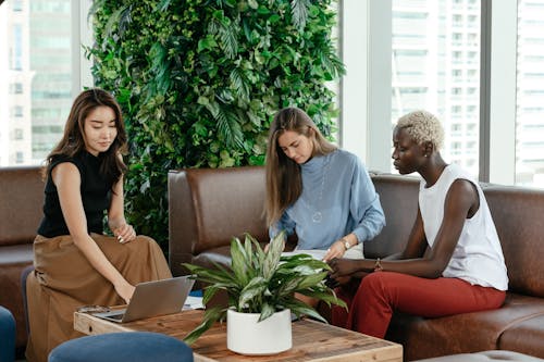 Diverse focused women working with papers and laptop