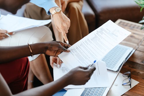 Free Multiethnic businesswomen checking information in documents Stock Photo