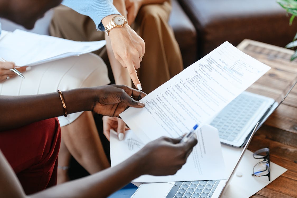 Multiethnic businesswomen checking information in documents - how to get 4 million visits per month