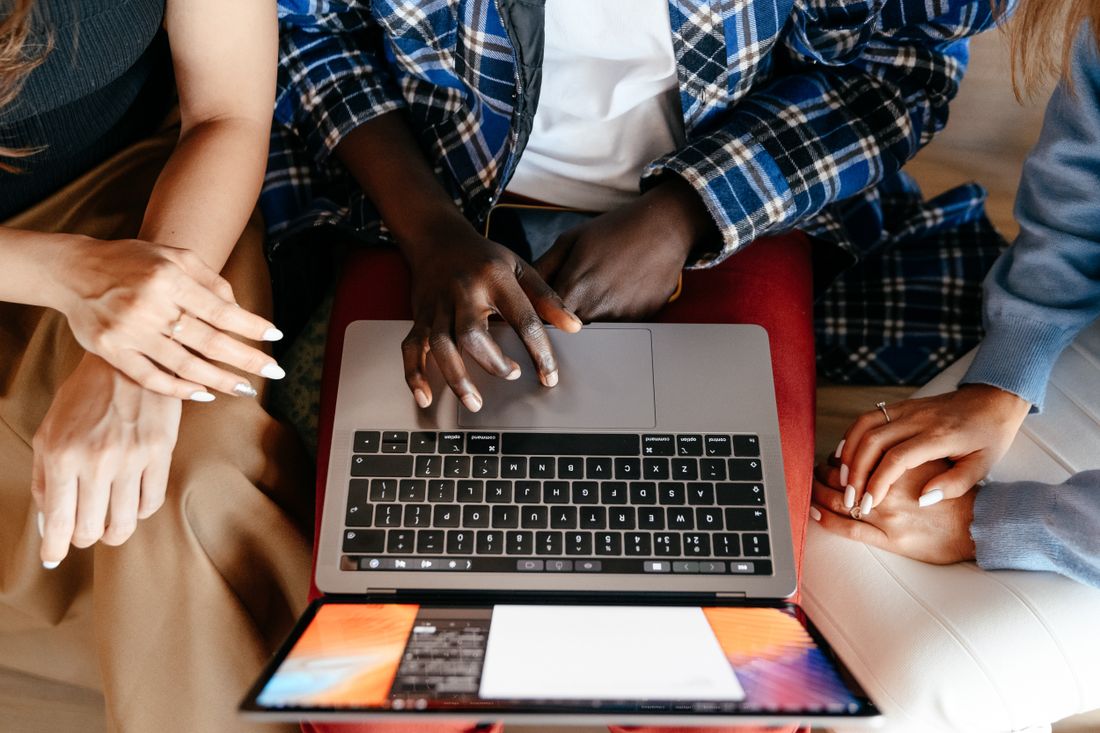 Two people building an online form together on a laptop