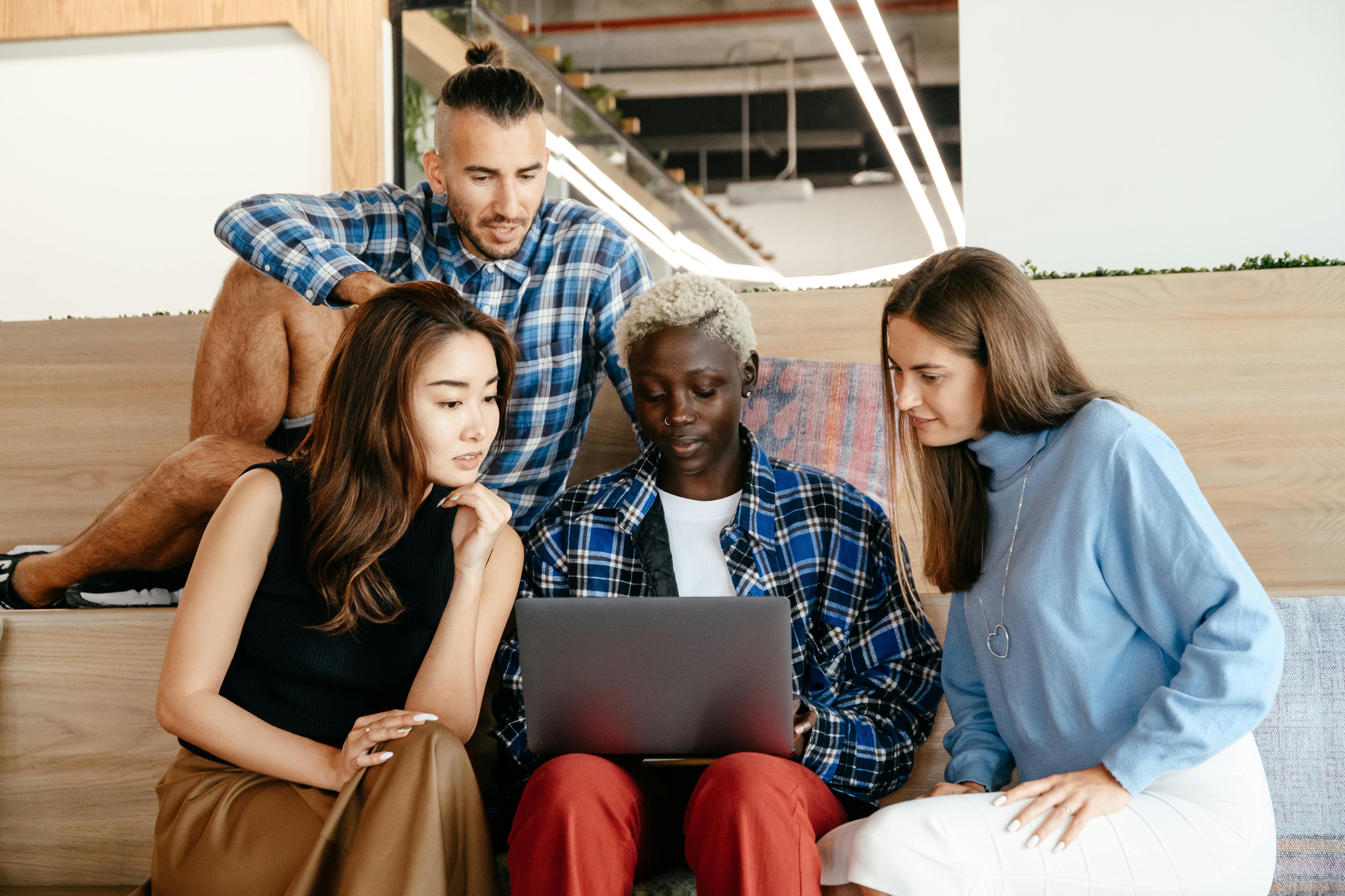 multiethnic students using laptop while studying