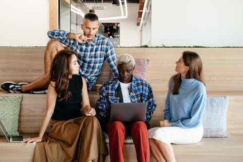 Diverse businesspeople discussing strategy while working with laptop