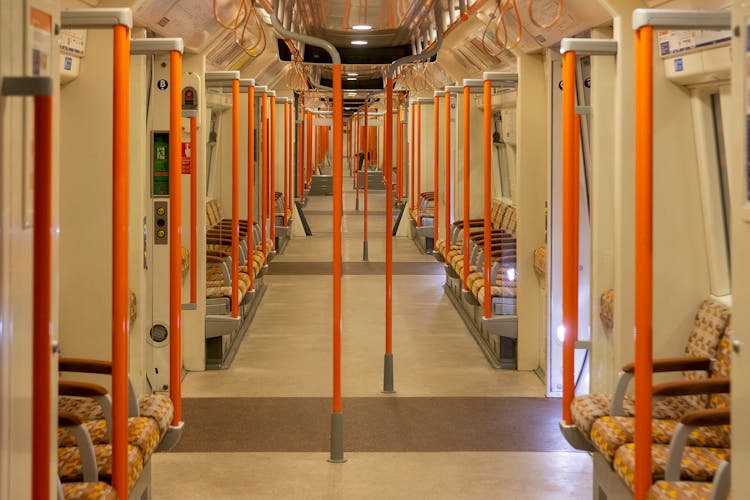 Orange And White Train Interior With Empty Seats