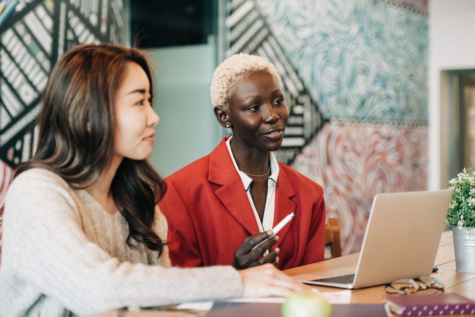 https://www.pexels.com/photo/thoughtful-multiracial-coworkers-sitting-at-table-with-netbook-in-modern-workspace-6457588/