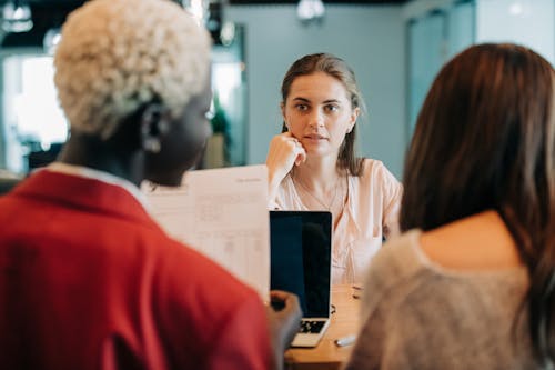 Diverse coworkers discussing project in workspace