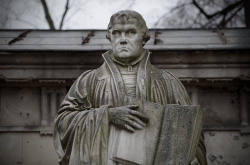 Brown Concrete Statue of Man