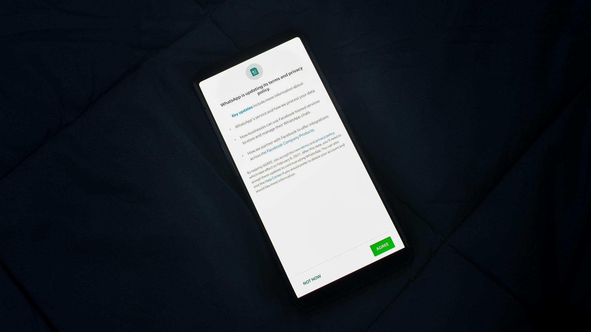 Close-up of smartphone screen showing a privacy policy update agreement.