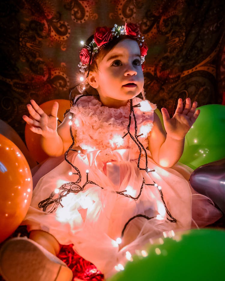 String Lights On A Cute Baby Girl