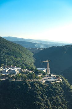 Stunning aerial view of Ghouma village nestled in the hills of Lebanon, showcasing lush green forests and mountains.