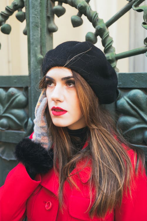 A Woman in Black Beret Hat and Red Coat
