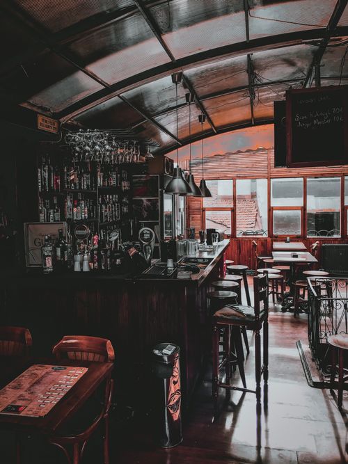 Free Contemporary bar with furniture alcohol and clean glasses prepared for visitors in morning Stock Photo
