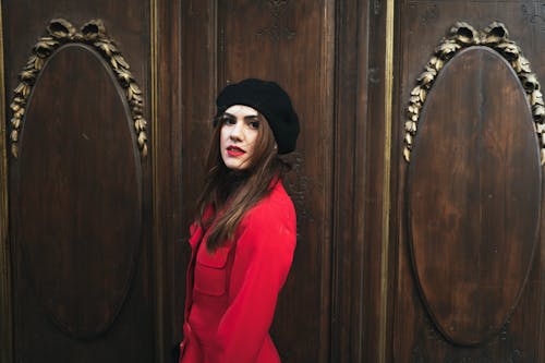 Woman Wearing Red Coat and Black Beret Hat 