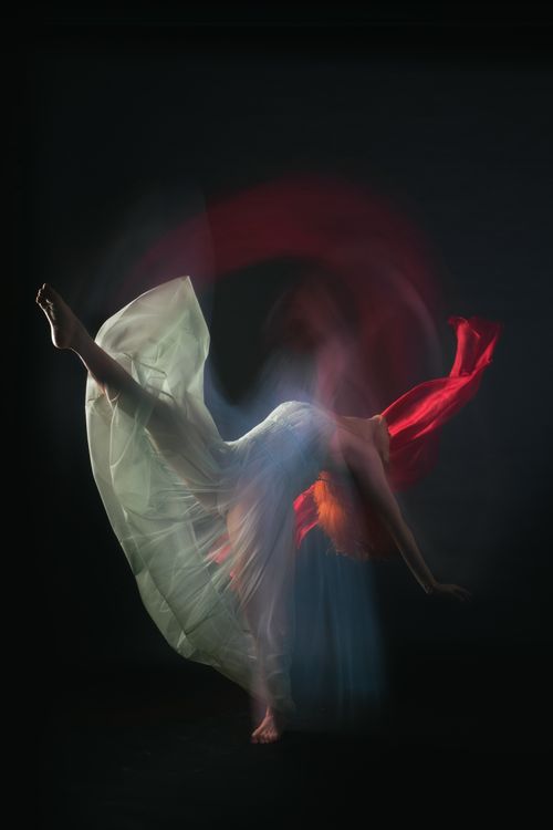 A Woman in White Dress Dancing Gracefully · Free Stock Photo