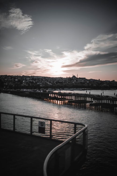 Free Tranquil pier of peaceful river with densely settled embankment under cloudy sunny sky Stock Photo