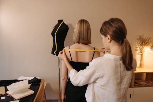 A Tailor Using a Measuring Tape