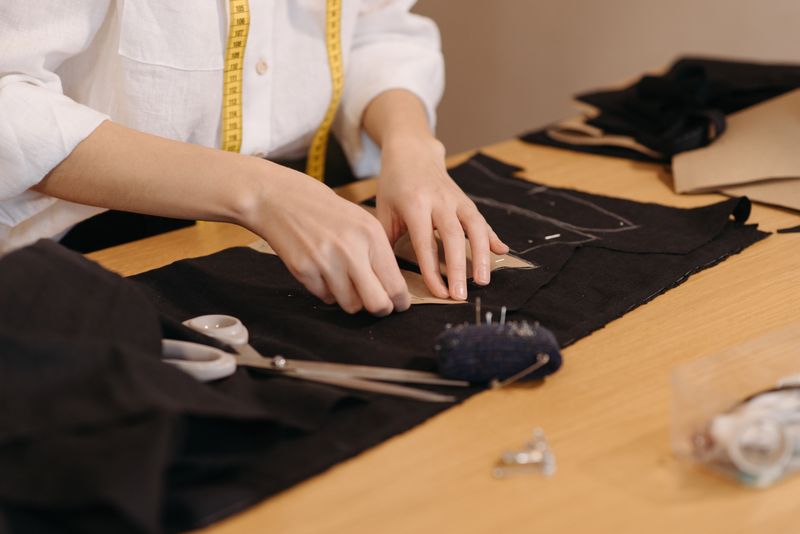 Fabric being cut at the Afera Studio workbench
