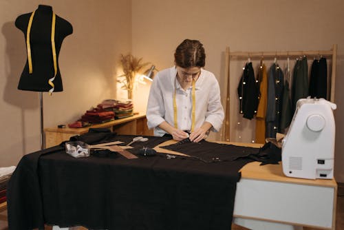 Woman Putting Markings on a Black Fabric