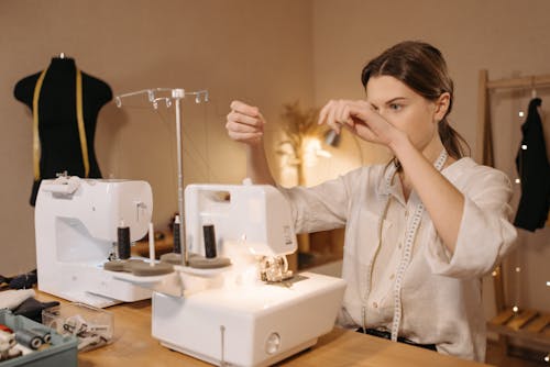 Woman Fixing a Sewing Machine
