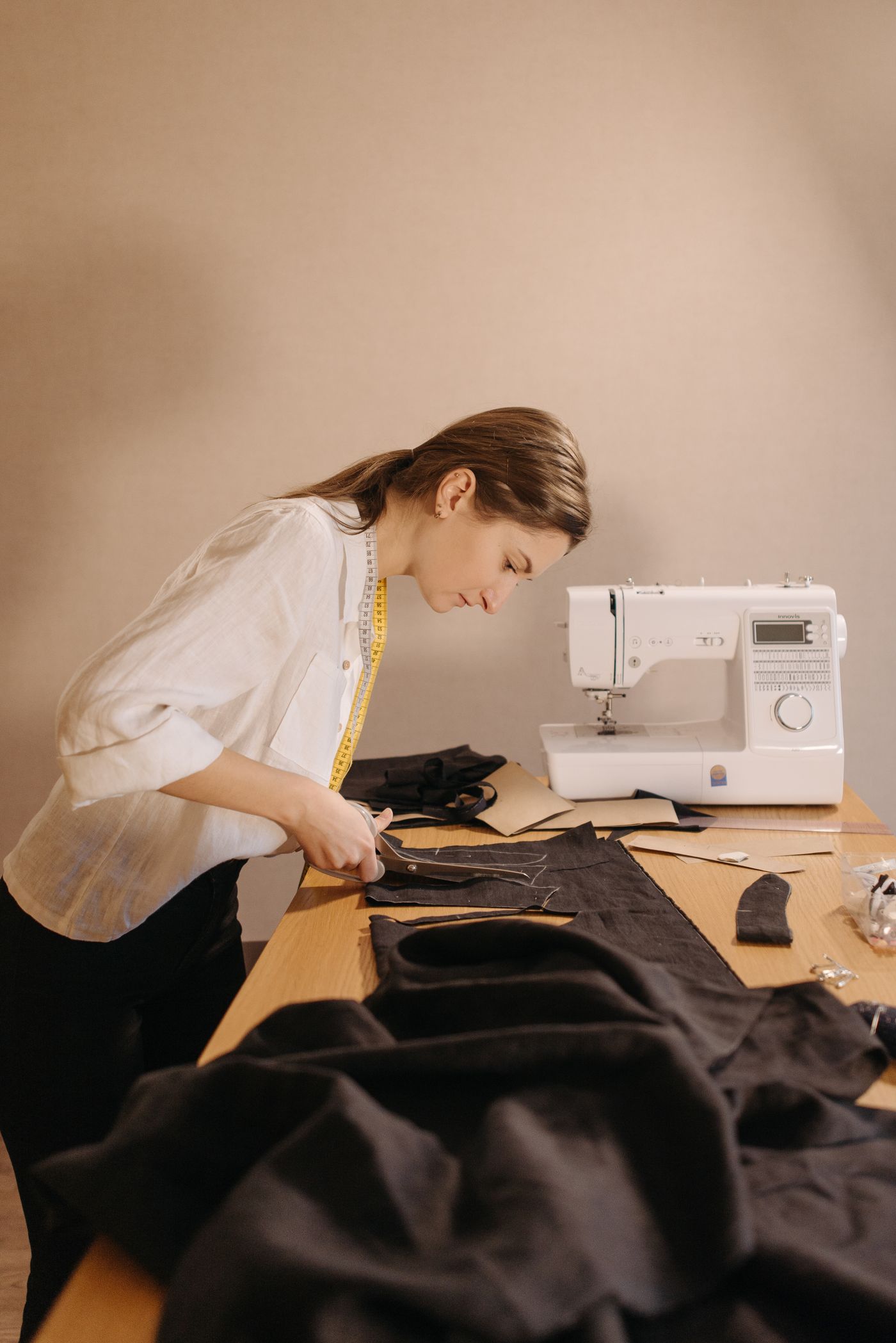 Garment fabric being measured and cut on a worktable