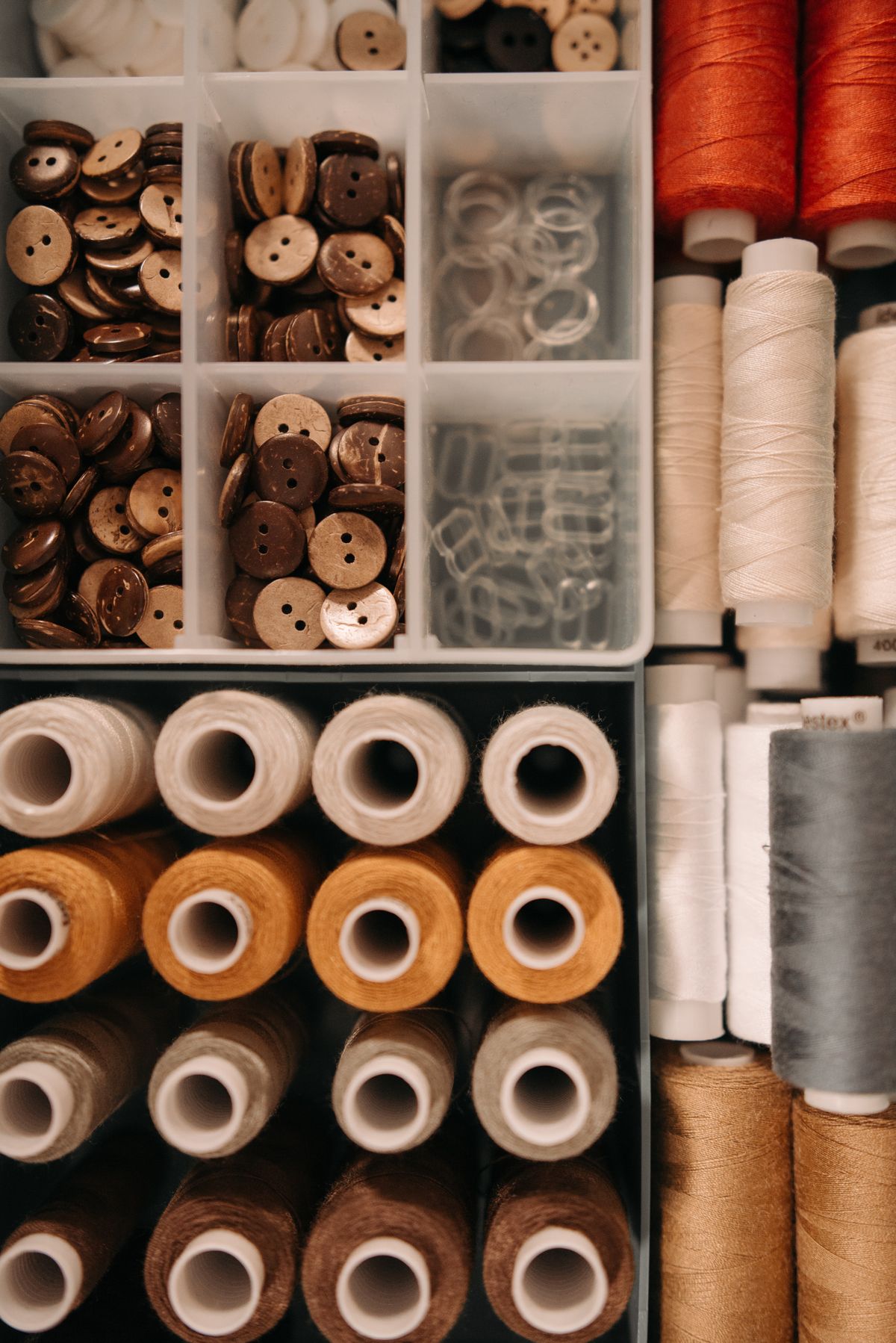 Craft supplies sorted into compartment bins