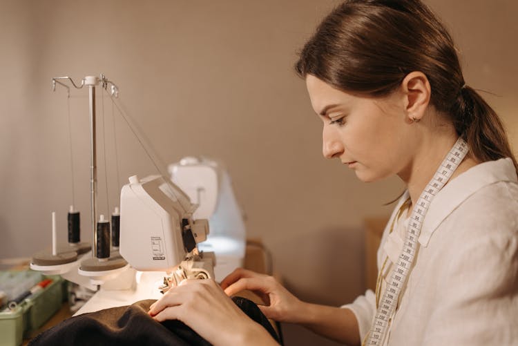 Dressmaker Sewing Fabric On Sewing Machine 