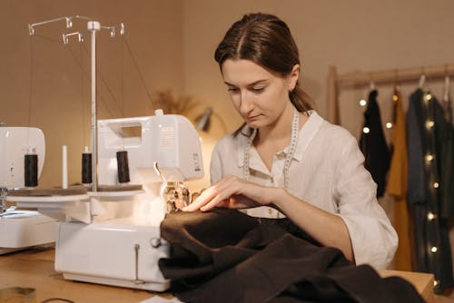 Dressmaker Sewing Fabric on Sewing Machine