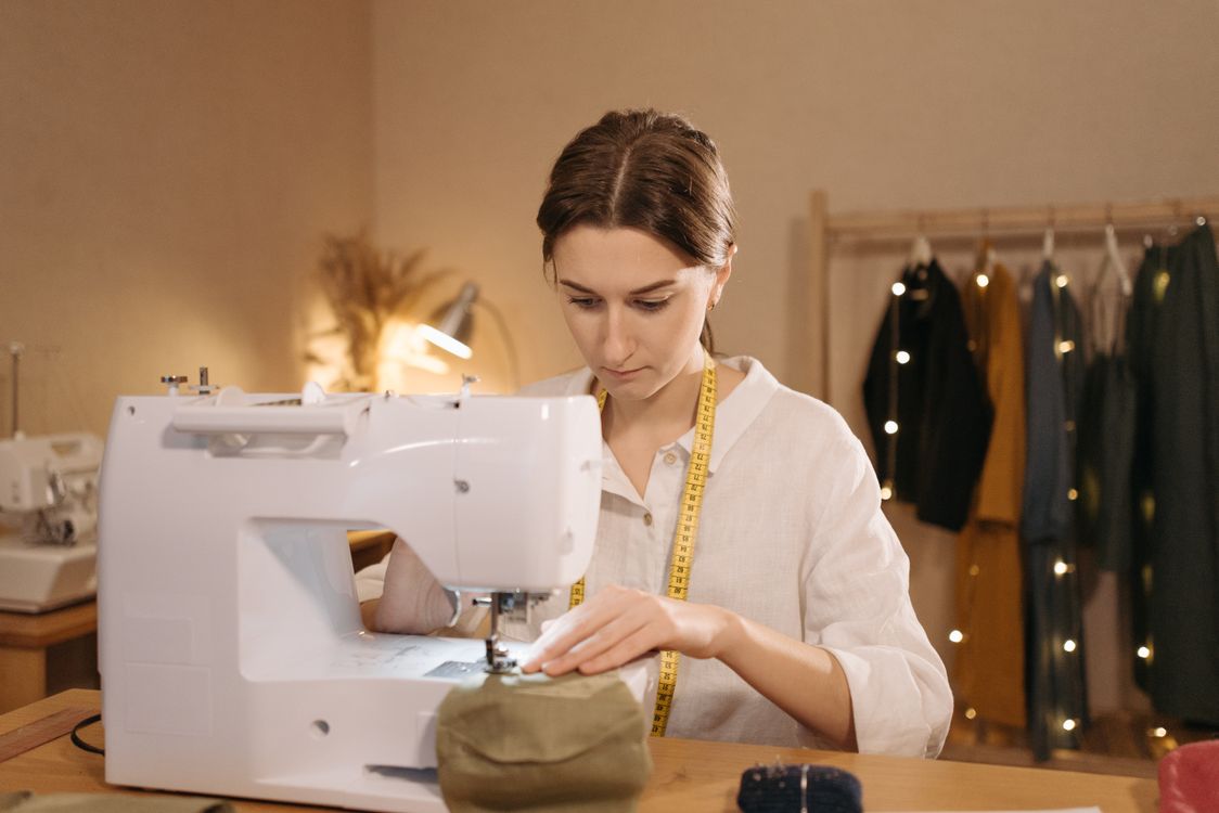 A Woman Using a Sewing Machine · Free Stock Photo