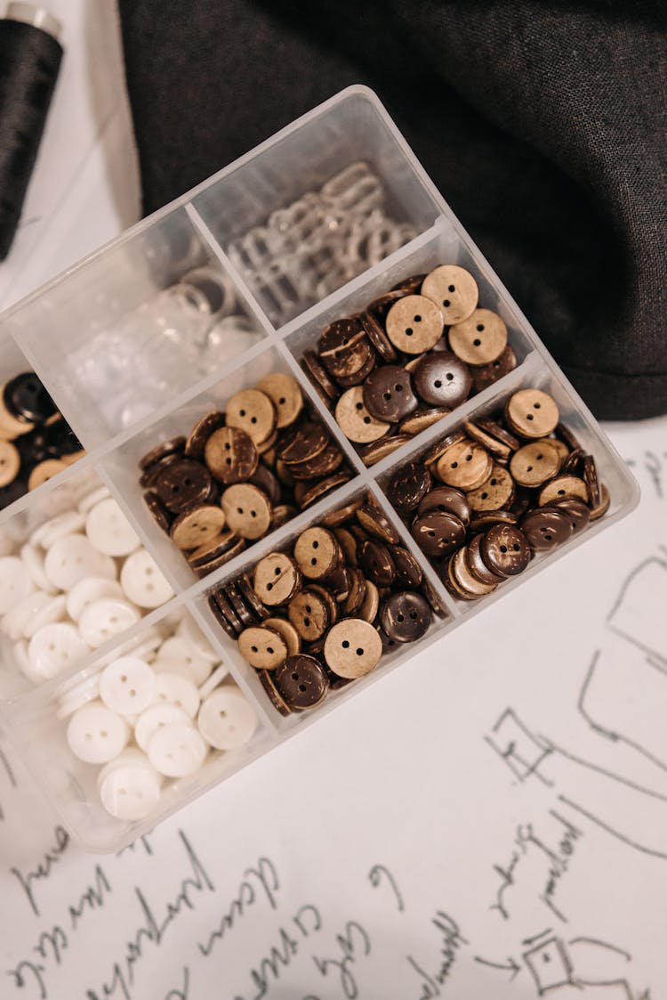 Buttons In A Plastic Container