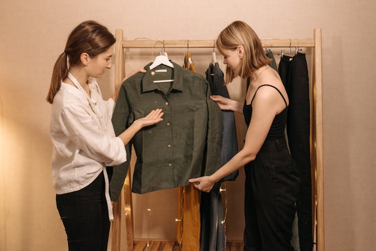Women Having Conversation While Holding Green Long Sleeves