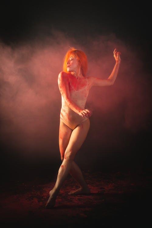 A Woman Dancing with Colored Smoke