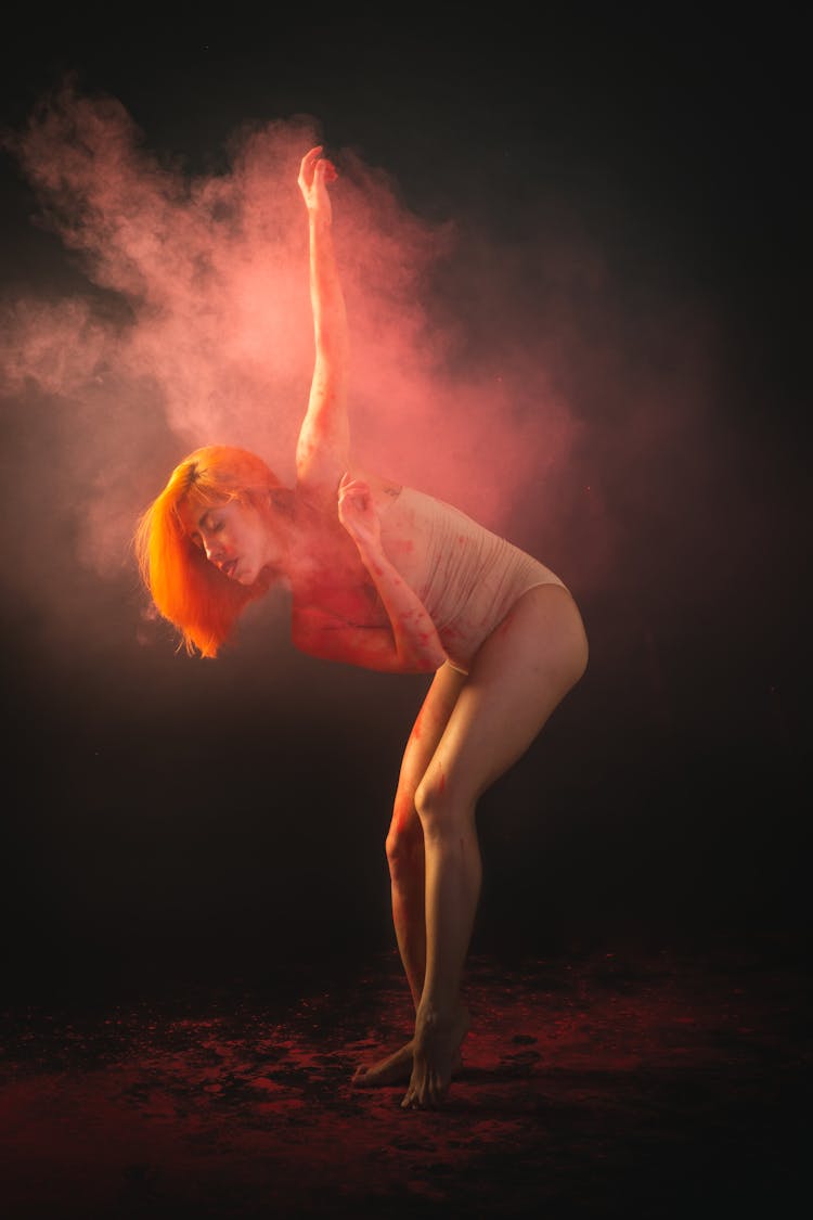 A Woman Surrounded By Colored Smoke