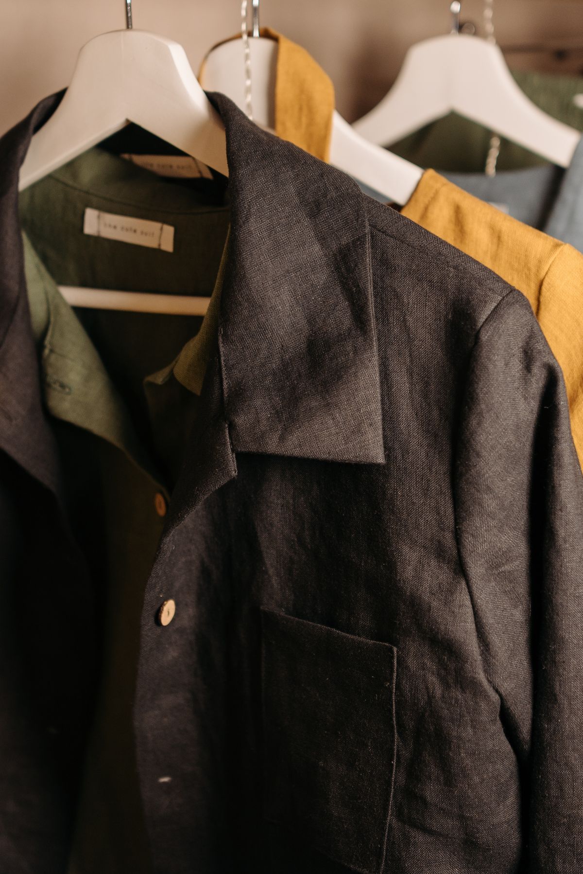 Unstructured jackets hanging in a quiet boutique interior
