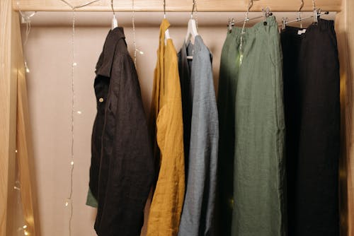 Clothes Hanging on Wooden Rack