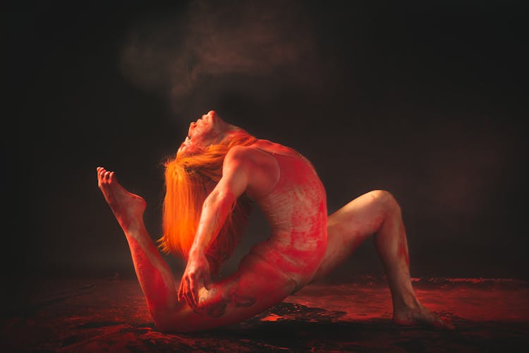 A Flexible Woman With Red Paint On Her Body