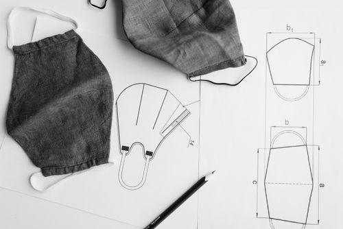 Free Detailed shot of fabric facemasks and sewing patterns, showcasing craft and design. Stock Photo