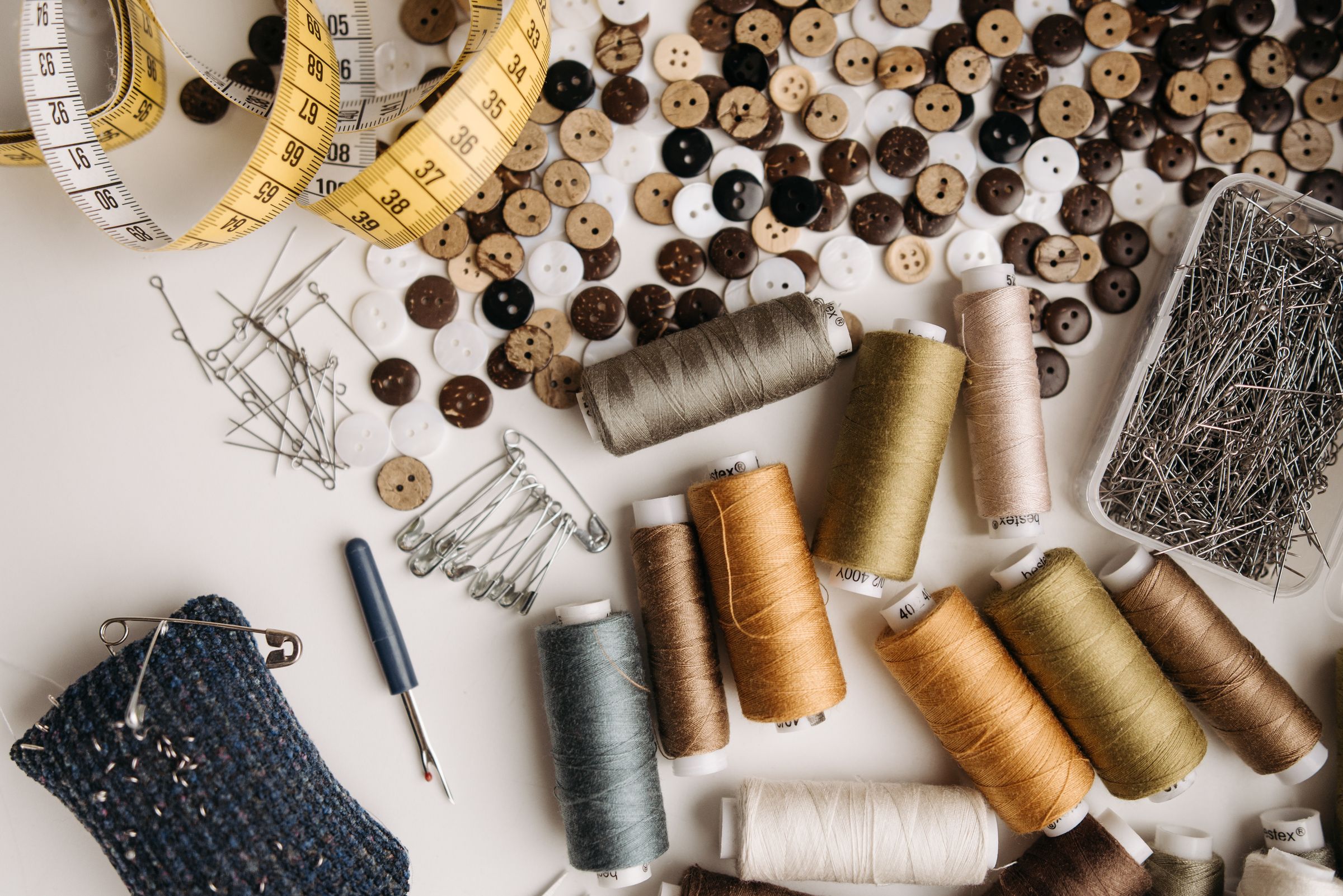 Sewing notions tabletop display planning with thread, buttons and measuring tools