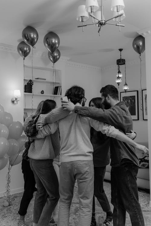 Free Group of Friends Hugging Each Other in Grayscale Photography Stock Photo