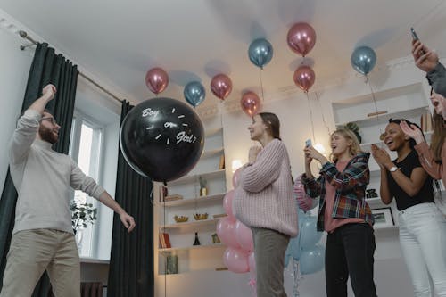A Man about to Pop a Balloon at a Gender Reveal Party