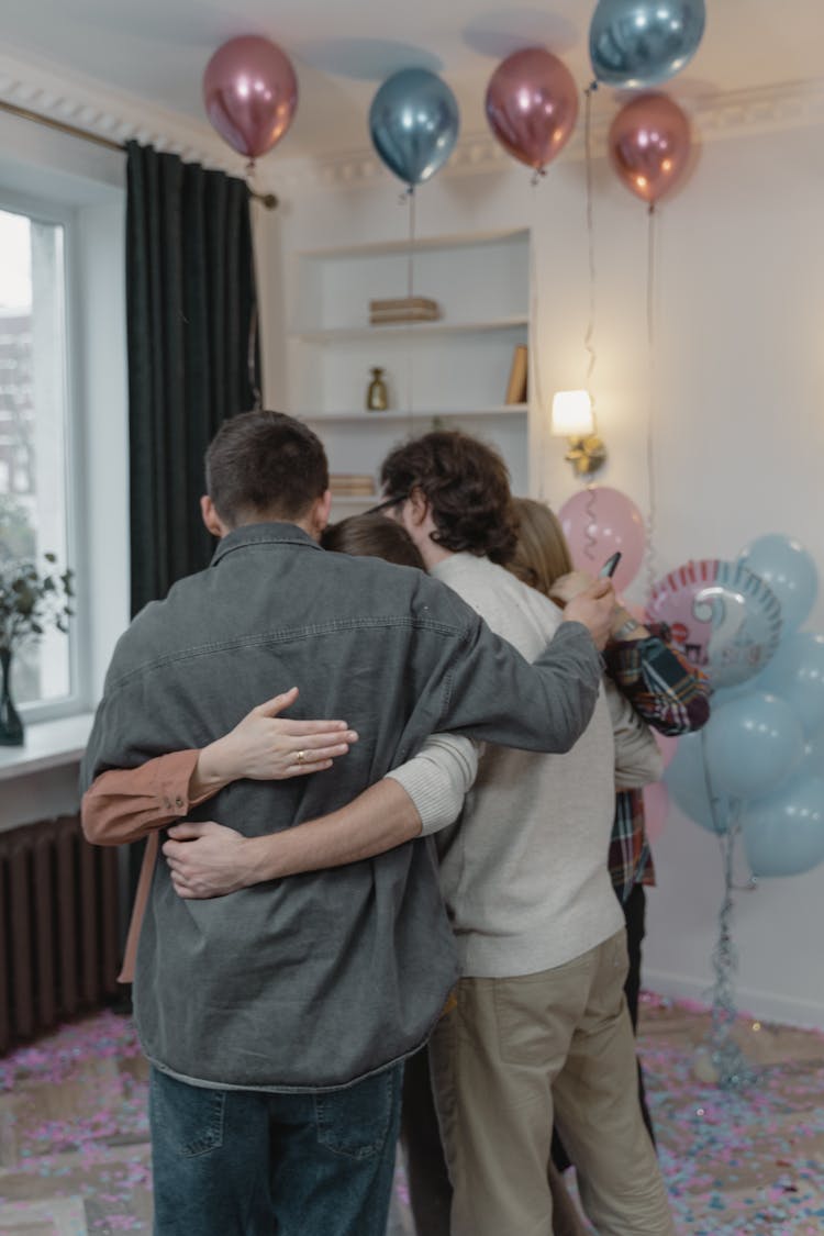 A Group Of People Embracing Each Other