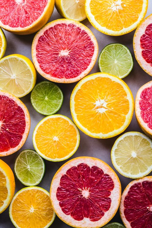 Free Vibrant halves of citrus fruits including oranges, grapefruits, lemons, and limes displayed in a fresh array. Stock Photo