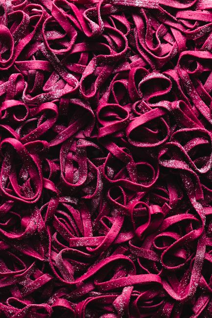 Flat lay shot of tangled vibrant pink ribbons for creative use.