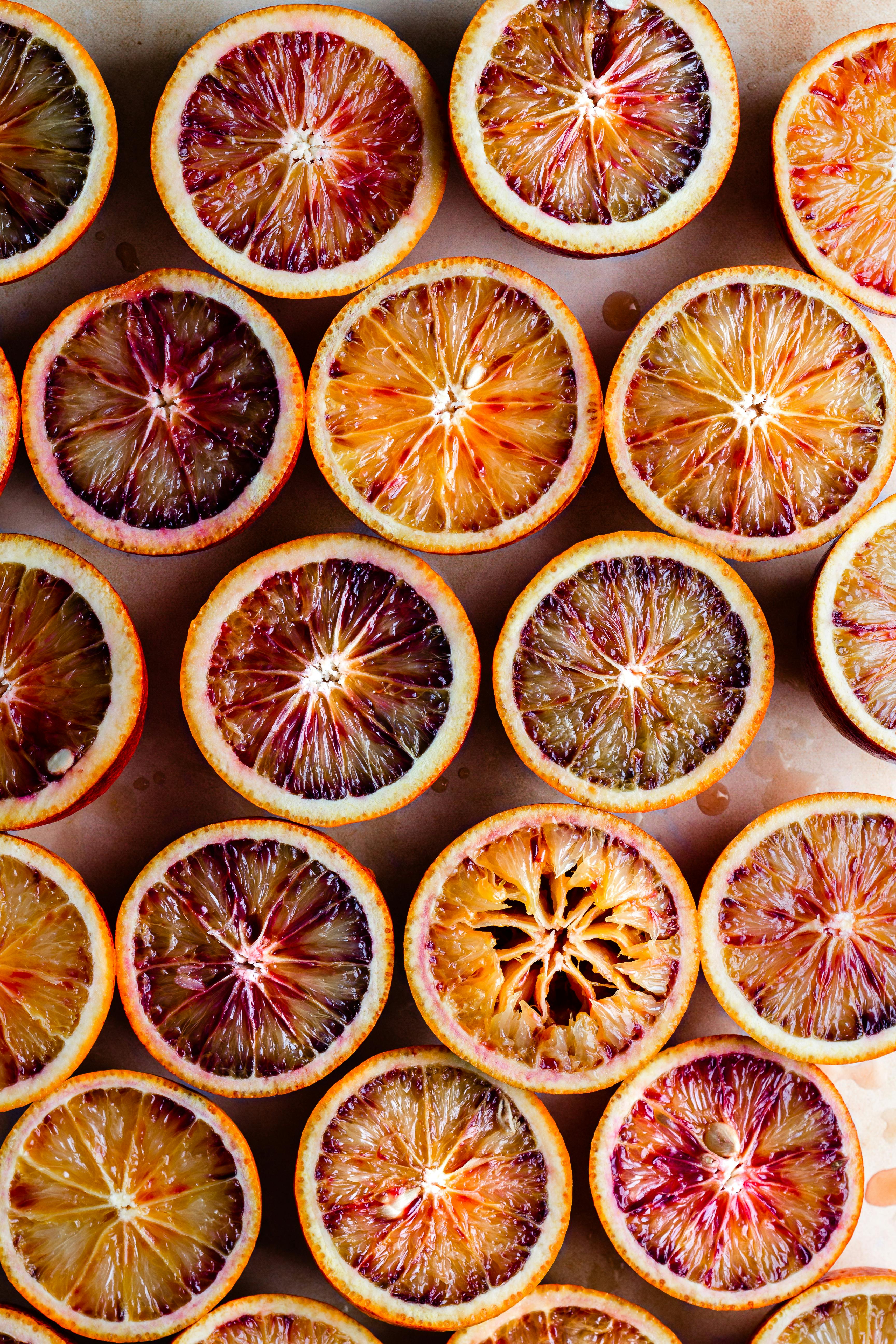 Top view of fresh blood orange slices in a colorful flatlay, showcasing their vibrant colors and textures.