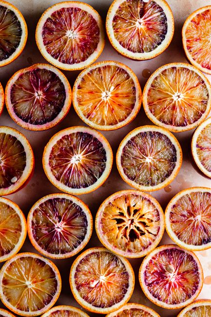 Top view of fresh blood orange slices in a colorful flatlay, showcasing their vibrant colors and textures.